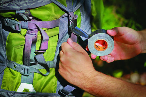 Person using Mini Duct Tape To Go Travel Size 1 Inch By 10 Yards Black Pack Of 3 Heavy Duty Double Thick Adhesive for backpack repair.