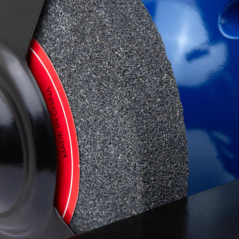 Close-up of grinding wheel on Eight Inch Heavy Duty Bench Grinder Workhorse Gutsy One Horsepower Motor Spinning At Three Thousand Four Hundred Fifty Rpm.
