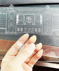 Front view of a clear square acrylic sheet, 5.9 in by 5.1 in, 4 mm thick, with protective film, held by hand.