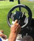 Golf Cart Steering Wheel Phone Mount Pro With Spring Loaded Arms And Scorecard Holder in use on golf course