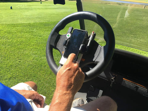 Golf Cart Steering Wheel Phone Mount Pro With Spring Loaded Arms And Scorecard Holder in use on golf course