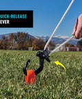 CamJam SlideLock Rope Tightener With Quick Release Lever secures rope in outdoor grassy field