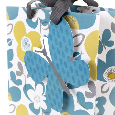 Medium Gift Bag With Tissue Paper Flowers And Butterflies In Turquoise And Yellow For Birthdays Mothers Day Bridal Showers Baby Showers And More Great For Gifting For Candles Books Scarves Or Small Gifts close-up of butterfly