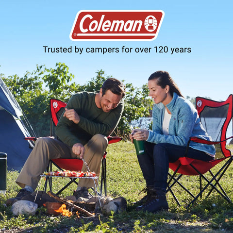 Couple sitting outdoors on Broadband Mesh Quad Camping Chairs with Carry Bag and Cup Holder, enjoying a campfire.