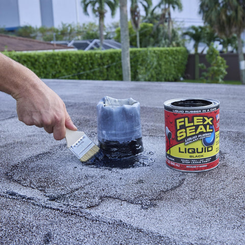 Brushing Liquid Rubber Sealant on roof, 16 oz can visible, watertight flexible coating, breathable and UV resistant