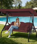 Three Seat Outdoor Porch Swing With Adjustable Canopy And Convertible Bed Two In One Patio Glider For Adults Cup Holder And Pillow Burgundy Red Backyard Relaxation by poolside with woman sitting