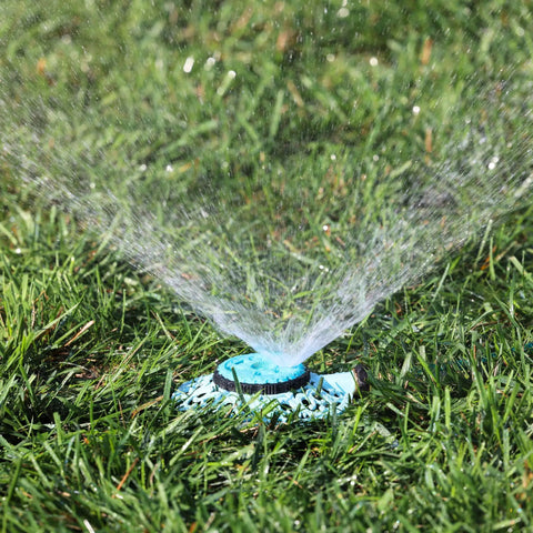 Sprout Metal 8 Pattern Sprinkler With Quick Connect Adapter Amazon Bundle In Gooseberry Green watering a lawn with fine spray