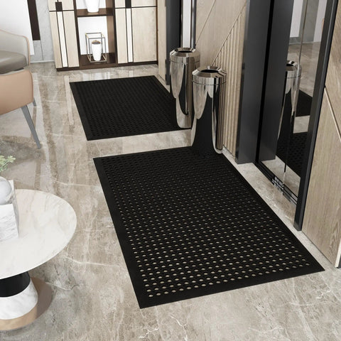 Heavy Duty Rubber Floor Mat With Grippy Non Slip Surface For Commercial Kitchens And Workshops, Waterproof And Hose Washable, Anti Fatigue Comfort, Oil Resistant, Perforated Drainage Design For Indoor Or Outdoor Use, 36 By 60 Inches, Black placed in an indoor entryway