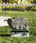 Killer Heavy Duty Outdoor Extension Cord Cover With Hinged Clear Window Stops Water In Its Tracks To Check Status Fast Rock Solid Weatherproof Shield Guards Outlets And Cords Against Rain And Debris Tough As Nails Build Includes 9X5X4.3 Model resting on grass, showing heavy duty plastic material.