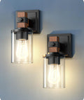 Top Tier Industrial Farmhouse Wall Sconces Set Of Two With Rustic Wood Grain Black Matte Finish And Clear Glass Shades, close-up view.
