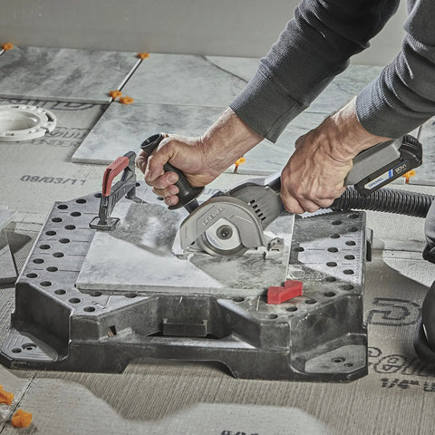 Person using the Rock Solid Heavy Lifter 20V Compact Circular Saw Kit on tiles with precision cutting for renovation.