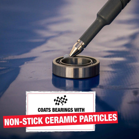 Application of Ceramic Bike Grease For Bottom Brackets, Hubs, And Headsets to a bearing on blue surface.