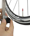 Rear Derailleur Hanger Alignment Gauge For Precise Drivetrain Tuning And Noise Reduction being used on bike wheel