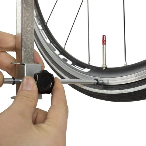 Rear Derailleur Hanger Alignment Gauge For Precise Drivetrain Tuning And Noise Reduction being used on bike wheel