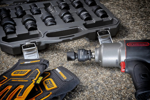 13 Piece One Half Inch Drive 6 Point Impact Socket Set SAE Heavy Duty CrMo Steel with gloves and power tool on concrete