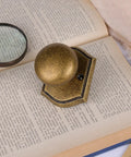 Antique Brass Interior Door Knob For Passage Doors on open book, vintage vibe, durable build, classic decorative hardware