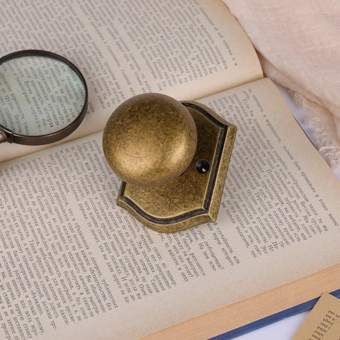 Antique Brass Interior Door Knob For Passage Doors on open book, vintage vibe, durable build, classic decorative hardware