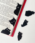 Six Pack Cute Cat Magnetic Bookmarks Clip Set for Readers and Students on open book page, assorted black cat styles