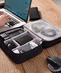 Waterproof Double Layer Electronics Organizer Bag For Cables Chargers Power Banks Adapters USB Cables Kindle Hard Drives And More Portable Travel Case On The Go With Adjustable Dividers open on desk with tech accessories