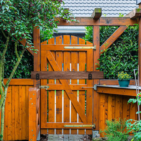 2x4 Door Barricade Brackets Heavy Duty U Shaped Security Holders For 2 By 4 Lumber installed on a wooden garden gate.