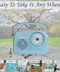 Grab N Go Portable AM FM Shortwave Radio Bluetooth Speaker in blue, with handle, set on grass with cherry blossoms in background