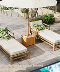 2 In 1 Outdoor Side Table With Storage In Acacia Wood Slatted Design With Umbrella Hole between two loungers by poolside