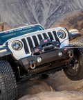 12,000 Lb Electric Winch For Trucks SUVs And Jeeps With Synthetic Rope 12V Heavy Duty Off Road Recovery Gear Built For Safe Handling And Beast Mode Spooling With Serious Pull Power mounted on Jeep bumper