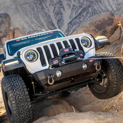 12,000 Lb Electric Winch For Trucks SUVs And Jeeps With Synthetic Rope 12V Heavy Duty Off Road Recovery Gear Built For Safe Handling And Beast Mode Spooling With Serious Pull Power mounted on Jeep bumper