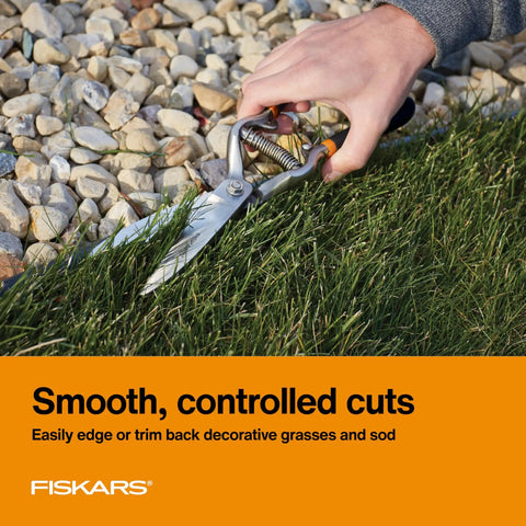 Pro Grade Forged Grass Shears for precise edging on grass beside stones, spring action reduces hand fatigue and offers smooth cuts.