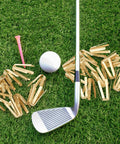 Boss Level Twenty Pack Brass Golf Shaft Adapter Shims For Three Thirty Five To Three Seventy Drivers Irons on grass with golf ball and club.