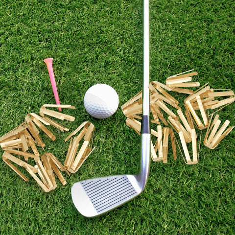 Boss Level Twenty Pack Brass Golf Shaft Adapter Shims For Three Thirty Five To Three Seventy Drivers Irons on grass with golf ball and club.