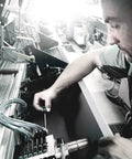 Technician using Kraftform Micro Ball End Hex Pro Grade Screwdriver Set for precision electronics adjustment at a workstation.