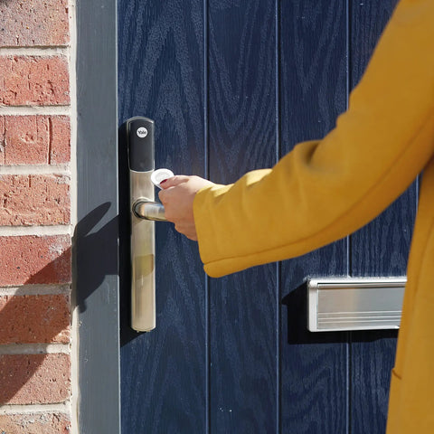 No Sweat Smart Keyless Front Door Handle With Polished Brass Finish And Smartphone App Control For Zero Stress Home Security in use.