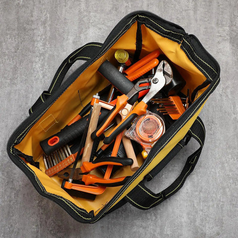 Top view of 3 Pack Heavy Duty Tool Bag With Waterproof Hard Bottom filled with assorted tools, 13 Inch, yellow interior.