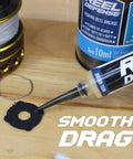 Reel Care Oil And Grease Kit With Two 10ml Syringes For Spinning And Baitcasting Reels, Works In Freshwater Saltwater Hardwater, Low Temp Performance -50F/-40C, All Weather Reel Maintenance For Smoother Casting And Longer Gear Life. 10ml grease syringe applying reel grease to fishing gear