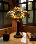 Amberwing Dragonfly Tiffany Style Table Lamp With Dope Multicolor Copper Foiled Glass, illuminated on a marble side table near window