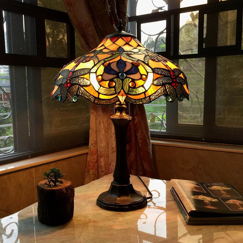 Amberwing Dragonfly Tiffany Style Table Lamp With Dope Multicolor Copper Foiled Glass, illuminated on a marble side table near window