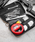Open orange compact semirigid utility organizer case showing first aid items and tools, designed for travel and electronics gear storage.