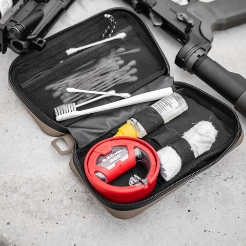 Open orange compact semirigid utility organizer case showing first aid items and tools, designed for travel and electronics gear storage.
