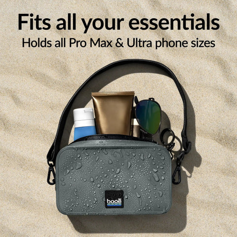 100 Percent Waterproof Fanny Pack For Beach And Travel with essentials on sand, showcasing IP67 dry bag design for phones