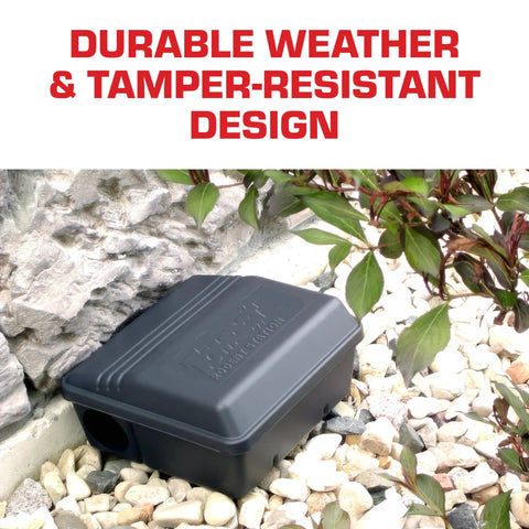 Rodent Station Trap Box With Four Bait Securing Rods And Security Key, Indoor Outdoor Weather Resistant next to a stone wall