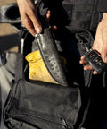 Close-up of Wakizashi Tactical Backpack 24L with MOLLE System showing a knife sheath and mesh pocket, black color.