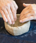 Hands shaping a bowl with Premium White Air Dry Clay 3.3 Lb Self-Hardening Ultra Fine With Exceptional Plasticity.