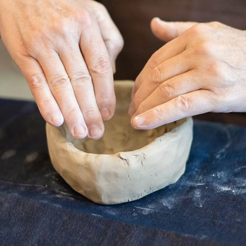 Hands shaping a bowl with Premium White Air Dry Clay 3.3 Lb Self-Hardening Ultra Fine With Exceptional Plasticity.