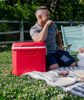 Profile II 16 Quart Red Cooler With Fold Flat Bail Handle, Cool Riser Technology at a picnic, tall bottle friendly design