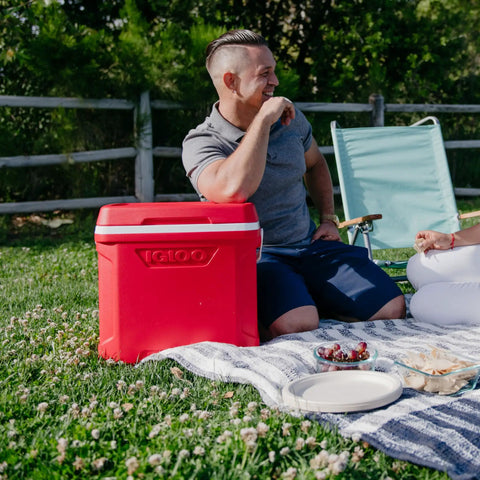 Profile II 16 Quart Red Cooler With Fold Flat Bail Handle, Cool Riser Technology at a picnic, tall bottle friendly design