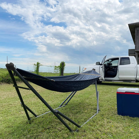 Adjustable Hammock With Sturdy Collapsible Stand For Camping And Outdoor Use 550 Lb Capacity Double Hammock shown outdoors