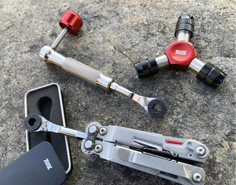 Go To One Quarter Inch Hex End EDC Ratchet Wrench For Multitools with Hex Bit Adapters on a stone surface