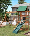 Children enjoying the Tough As Nails Wood Backyard Swing Set with wave slide, rock wall, belt swings, play deck, and canopy roof.