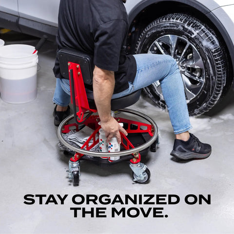 Man using under seat tool tray organizer for EZ Lift chairs, heavy duty steel construction with rubber mat, in garage setting